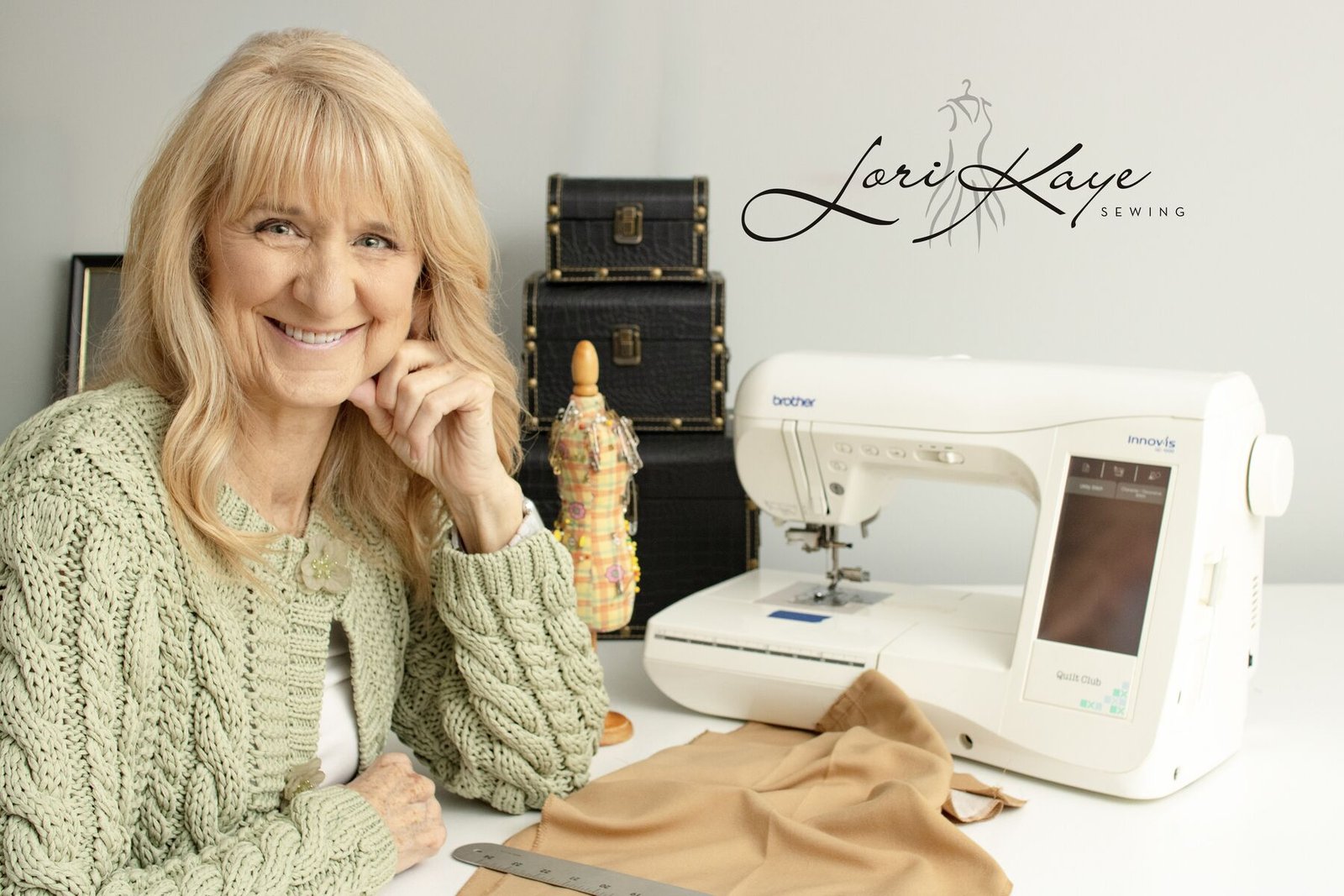 Lori Kaye at her sewing machine in her Cary, North Carolina studio, with the Lori Kaye Sewing logo